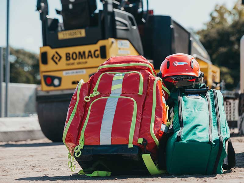 Red and green medical bags on a construction site